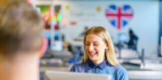 Lidl employee smiling at a till